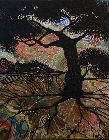 Silhouette of a tree on a sunset colored background.